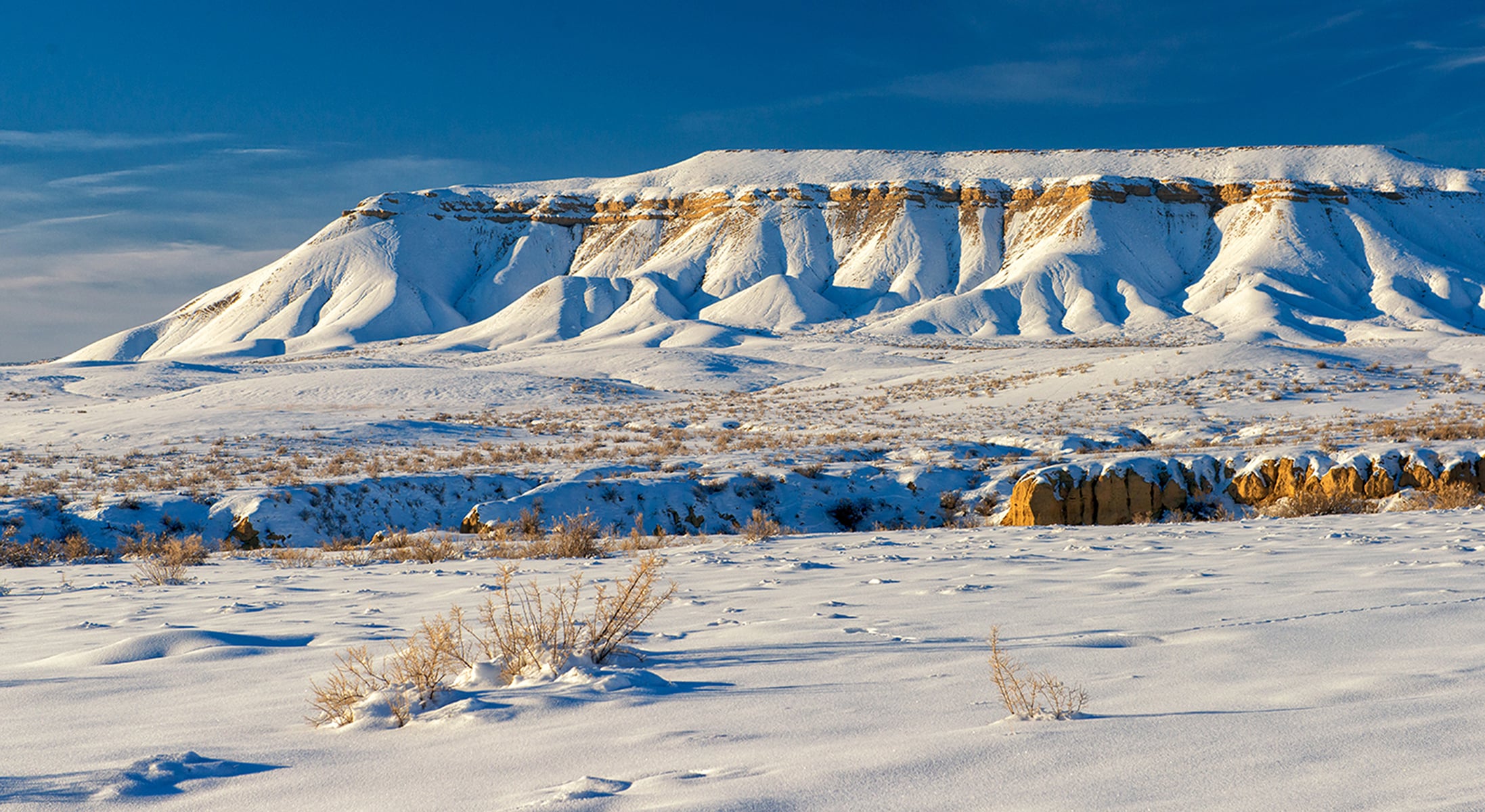 A mesa looks like it is covered in powdered sugar instead of snow in Rio Blanco County, Colorado